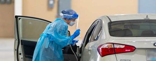 A public health worker prepares to test a person for COVID-19 at a drive-through testing site in San Antonio. - COURTESY PHOTO / CITY OF SAN ANTONIO