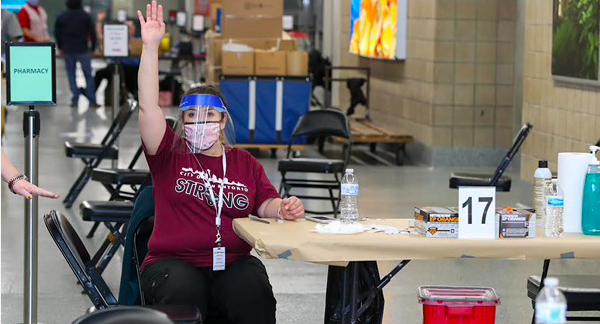 A worker at San Antonio's Alamodome vaccination site calls for the next person to receive a shot. - COURTESY PHOTO / CITY OF SAN ANTONIO