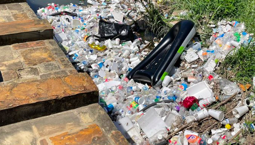 This photo shared on Twitter shows litter washed up along the banks of the San Antonio river near Confluence Park. - TWITTER / @RYAN_SERPICO