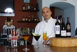 West Avenue Kitchen owner and chef Rick Frame sets up cocktails at his restaurant’s full bar.
