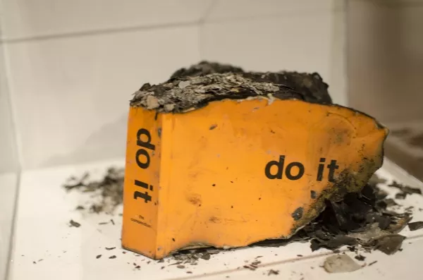 A burned instruction book from UMOCA's do it.