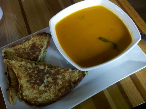 A gooey grilled-cheese sandwich paired with tomato & basil soup.