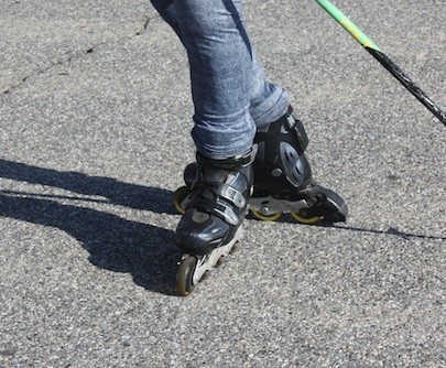 A T-STOP IS EXACTLY WHAT IT SOUNDS LIKE. ONE FOOT IS PLACED BEHIND THE OTHER IN A "T" POSITION, WITH THE WHEELS TILTED TOWARD THE HEEL OF THE OTHER SKATE. PRESSURE IS PUT ON THOSE WHEELS, AND THE DRAGGING MOTION WILL BRING YOU TO A STOP. THE HARDER THE PRESSURE, THE QUICKER THE STOP. DON'T BE AFRAID TO PRESSURE DOWN HARD ON THE BACK SKATE. - JOHN SWENSON