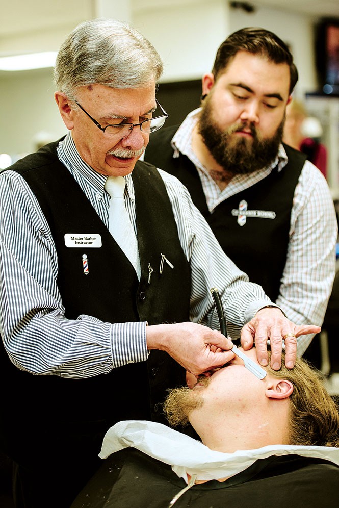 Milton Larsen, master barber instructor at The Barber School, demonstrates a straight-razor shave