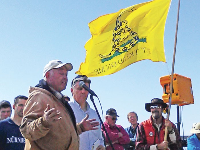 San Juan County commissioner Phil Lyman listens as a speaker addresses the crowd at the ATV rally - ERIC TRENBEATH