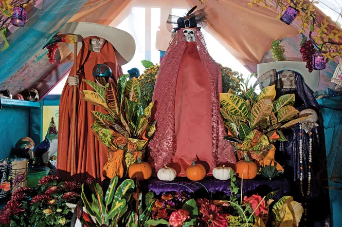 Santa Muerte is “muy cabrona, muy macha. If you do everything right, if you are a believer, she’ll protect you.” - —Alvina Tavera, owner of Botanica San Antonio, whose altar in honor of Santa Muerte is pictured - NIKI CHAN