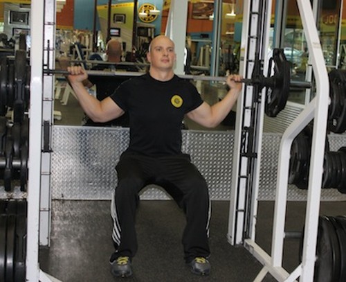 THE SMITH MACHINE ALLOWS YOU TO CHOOSE WHICH MUSCLES WORK MOST IN A SQUAT. AN UPRIGHT POSTURE PUTS MORE RESISTANCE ON THE BACK. FEET FORWARD WORKS THE CORE. PUT MORE PRESSURE ON THE INSIDE OF ONE FOOT AND OUTSIDE OF THE OTHER, THEN SWITCH TO WORK THE ADDUCTORS AND ABDUCTORS. - BY WINA STURGEON