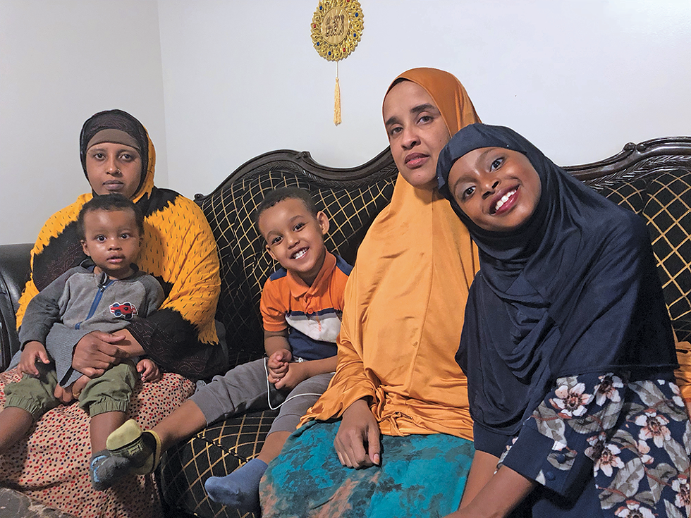 Sadia Osman (second from right) raises a 3-year-old son and spends a lot of time with her cousin and her children, but she misses her boys every day. “We have everything, but we miss part of our lives, like our kids,” she says of refugees resettled in the U.S. - KELAN LYONS