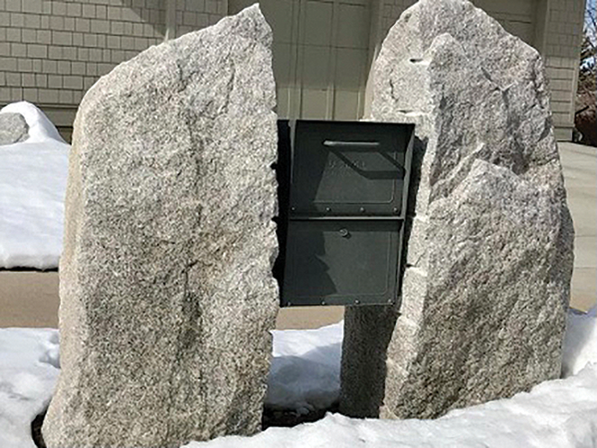 A mailbox in the Millcreek’s Mount Olympus neighborhood is caught between a rock and an equally hard rock. - BRYANT HEATH
