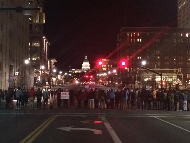 Protesters form a circle in the intersection of 100 South and State Street. - COLBY FRAZIER