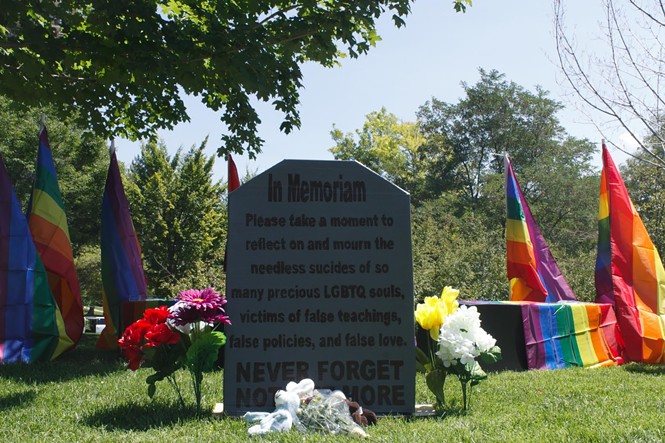A mock tombstone was erected on Saturday to mark LDS LGBTQ lives lost. - JORDAN FLOYD