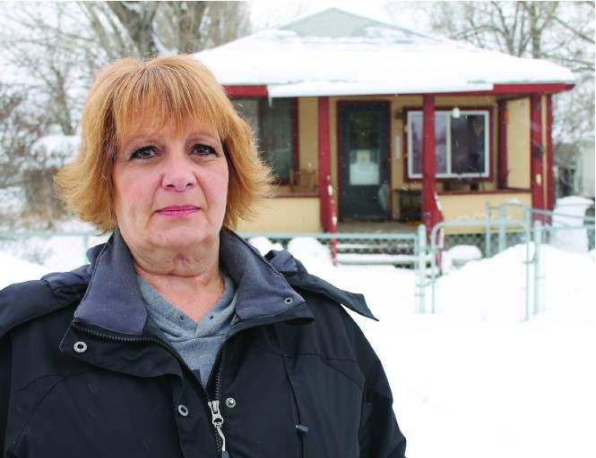 Heidi Jones-Asay stands in front of the house where her mother was killed in late July 1970.