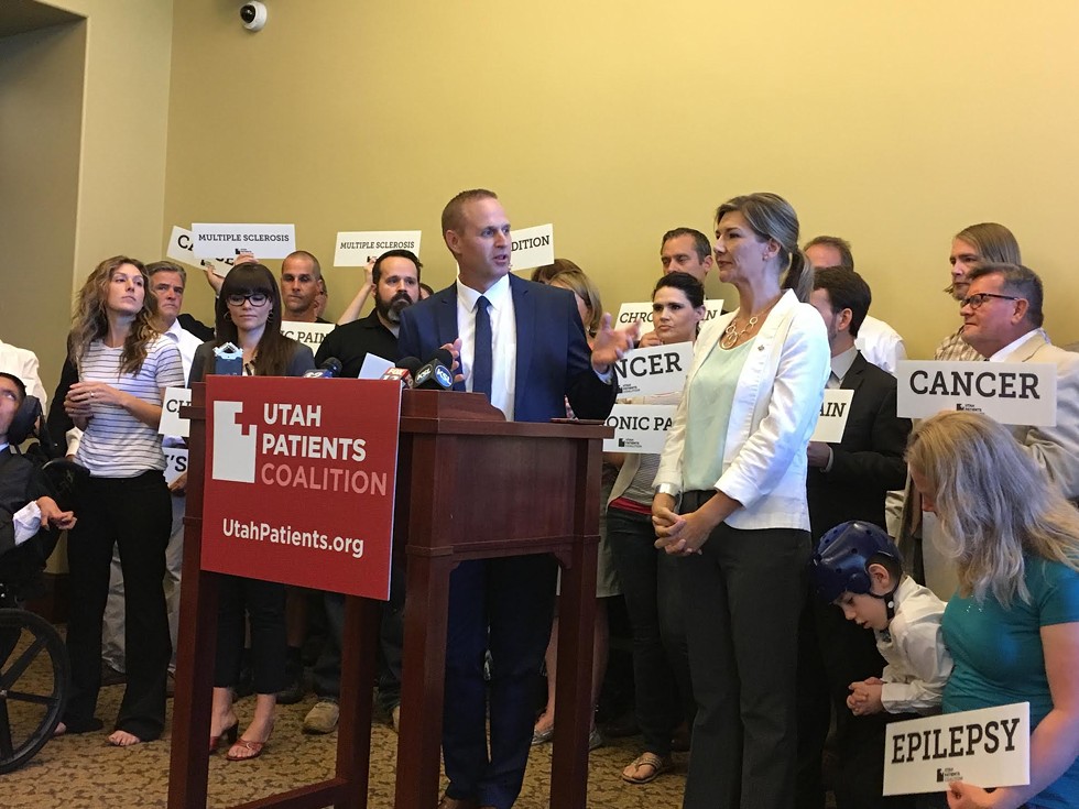 Utah Patients Coalition campaign director DJ Schanz speaks at the podium during a press conference at the Capitol on Monday. - DW HARRIS