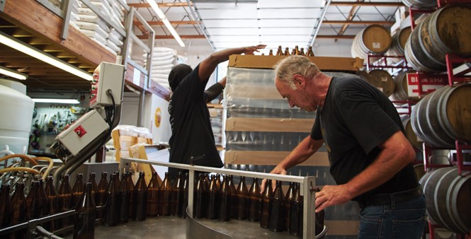 11. Greg Giles and Haley work the bottling process.
