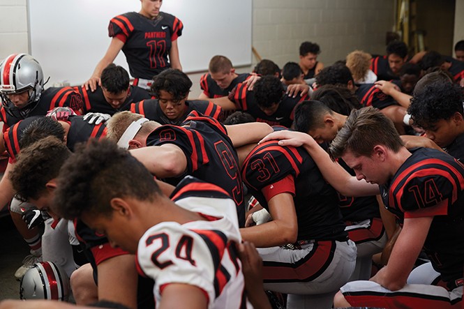 The Panthers huddle in prayer last Friday evening before the season opener. - STEPHEN VARGO