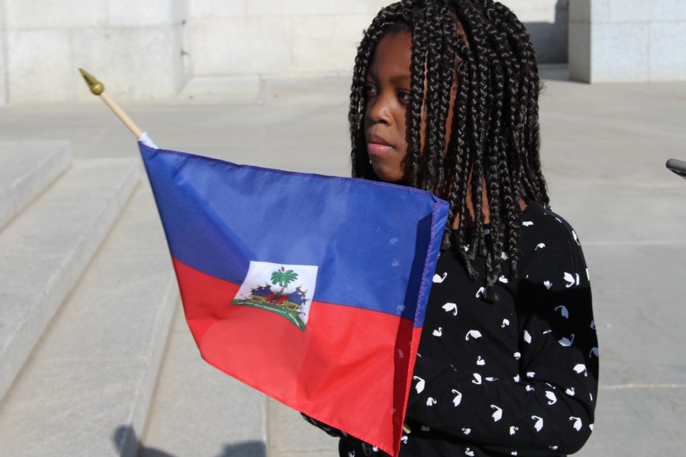 A little girl waves the flag of Haiti during SLC's Rally Against Racism. - ENRIQUE LIMÓN