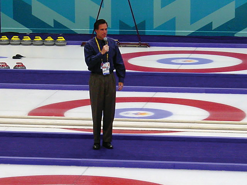 CEO of the Salt Lake Organizing Committee, Mitt Romney—in all his pleated-pants glory—says a few words before a curling event at the 2002 Games. - UNCLEWEEK VIA WIKIMEDIA-COMMONS