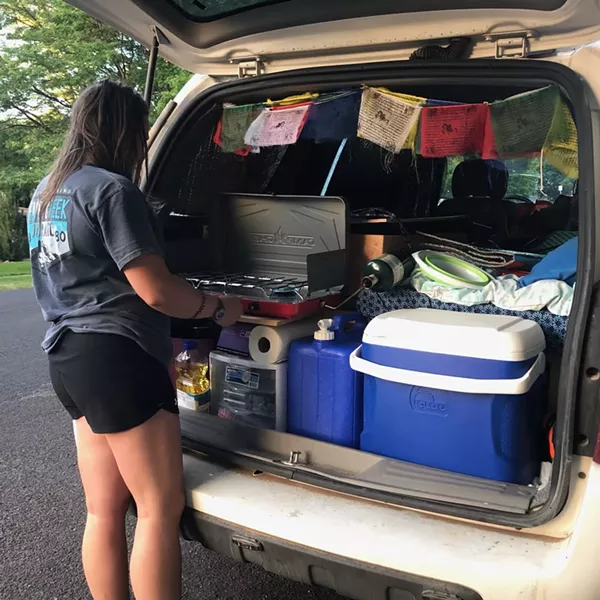 USU student Stephanie Buchanan fires up a quick meal in the cramped-yet-efficient back of Moby Dick, her Chevy Uplander. - COURTESY PHOTO