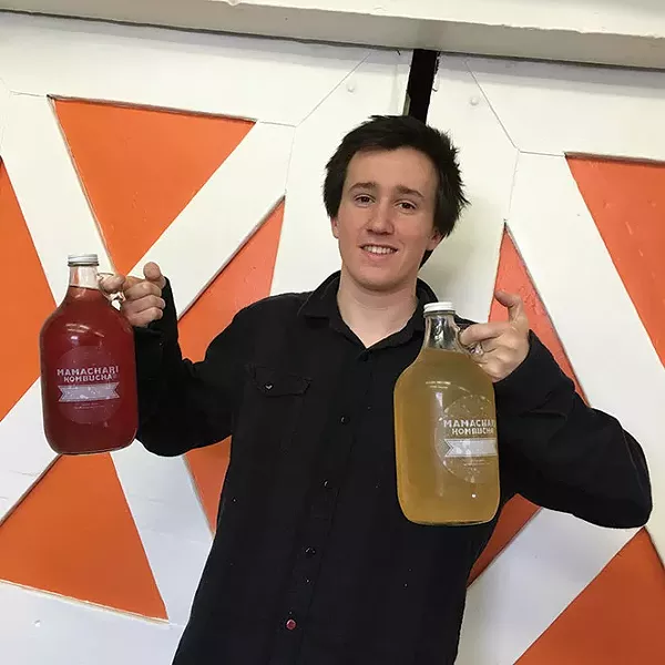 Customer Ian Lampson fills his growlers.