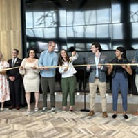 Salt Lake City Mayor Erin Mendenhall, center, cuts the ribbon at the new Post District residential and commercial development on Thursday, May 2, 2024.