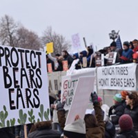 Protesters hold up various signs ahead of President Donald Trump’s visit to the Utah State Capitol Building on Monday, Dec. 4. Trump signed two presidential proclamations shrinking the size of the Grand Staircase Escalante and Bears Ears national monuments.
