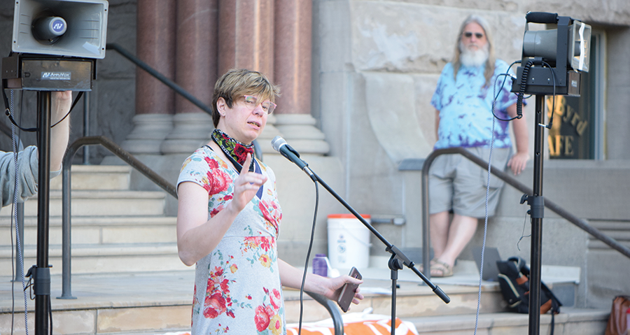 Amie Annsa describes her experiences with homelessness to the crowd gathered outside the City and County Building ahead of a recent City Council meeting regarding single-room occupancy units. - RAY HOWZE
