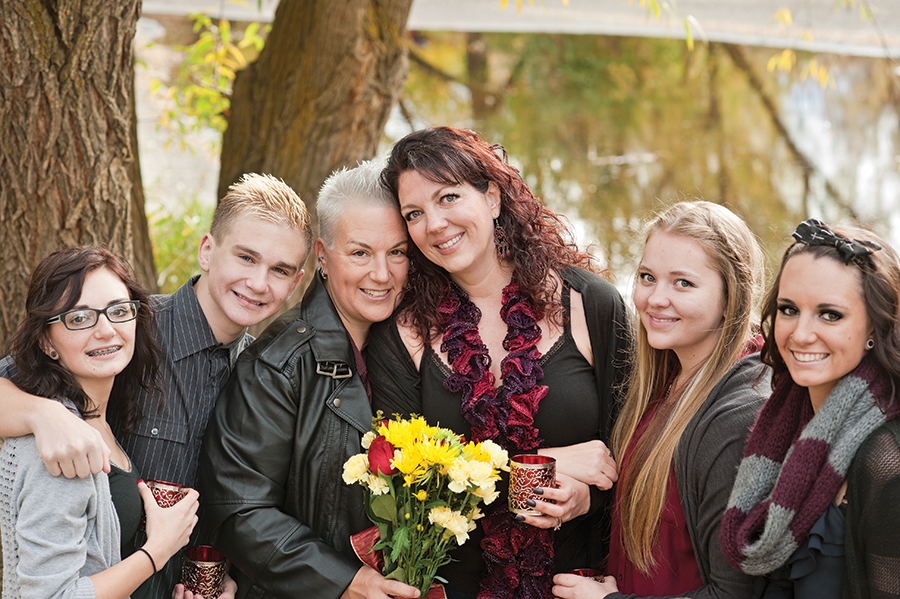 Kimberly Hansen-Ennis, center-right, and her wife, Kelli, with their family - COURTESY PHOTO