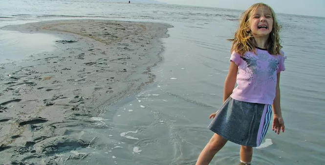 The author’s daughter sinks into the soft lake bed. - RANDY HARWARD