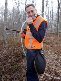 Gov. Peter Shumlin imitates a bear chewing on a sugar-bush line.