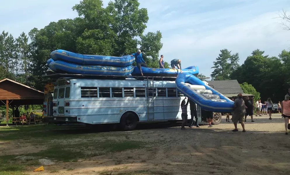 Loading rafts onto the bus - ANDREA SUOZZO