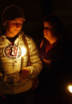 Nicole Proulx of Plainfield holds a candle during a “Take Back the Night” vigil in Montpelier - JEB WALLACE-BRODEUR