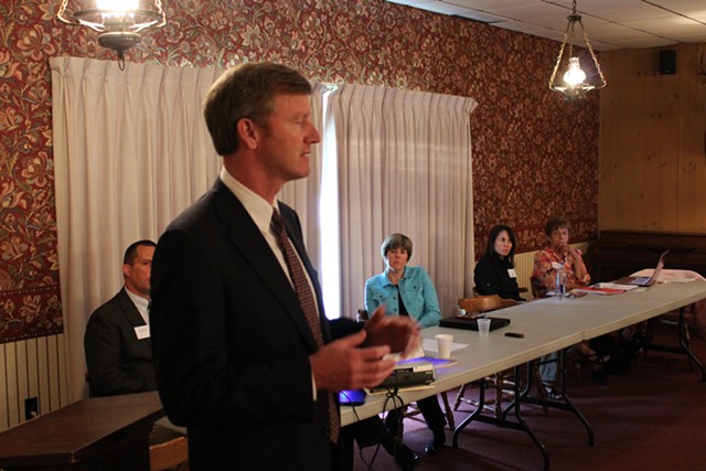 Susie Hudson, seated in blue, listens to gubernatorial candidate Scott Milne at a Vermont Republican Party meeting in Barre in June 2014. - FILE: PAUL HEINTZ