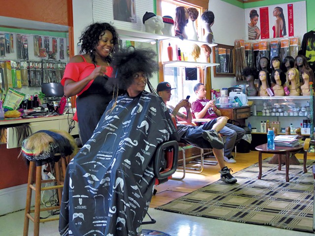 Mistre Newton gets her hair done at Burlington's Diversity Hair Salon. - MATTHEW THORSEN