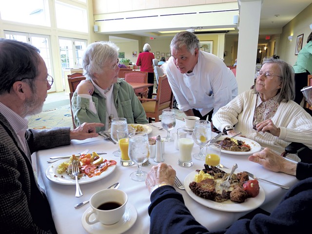 Bill Koucky visiting with residents in the dining room - MATTHEW THORSEN