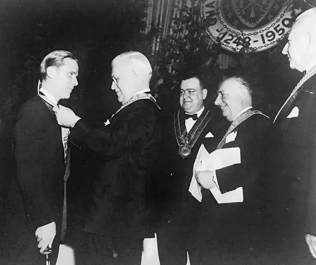 Spitler's father (left) being inducted to La Confrérie de la Chaîne des Rôtisseurs by her grandfather in New York City, circa 1960 - COURTESY OF CHAÎNE DES RÔTISSEURS