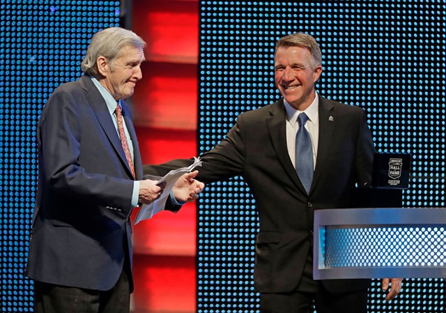 Gov. Phil Scott (right) inducts Ken Squier into NASCAR's Hall of Fame in Charlotte, N.C. - AP PHOTO/CHUCK BURTON