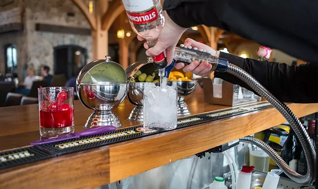 Mixing a vodka tonic at the Hermitage Club in Wilmington - ZACHARY P. STEPHENS