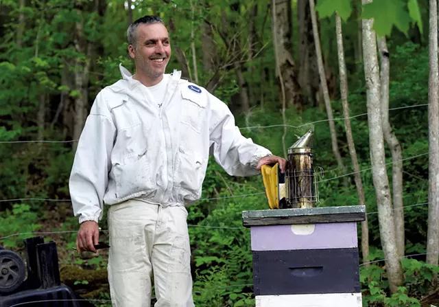 David Tremblay with a hive in Montpelier - JEB WALLACE-BRODEUR