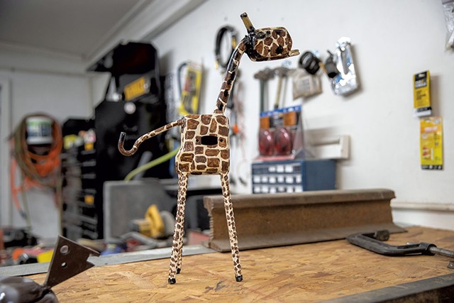 One of LaRock's metal creations, a miniature of the giraffe that stands outside his South Burlington auto-body shop - JAMES BUCK