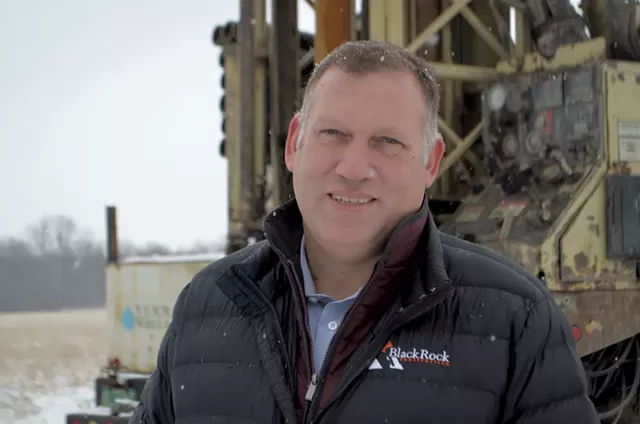 Ben Avery of BlackRock Construction in front of well-drilling equipment in Hinesburg - PHOTOS: MOLLY WALSH