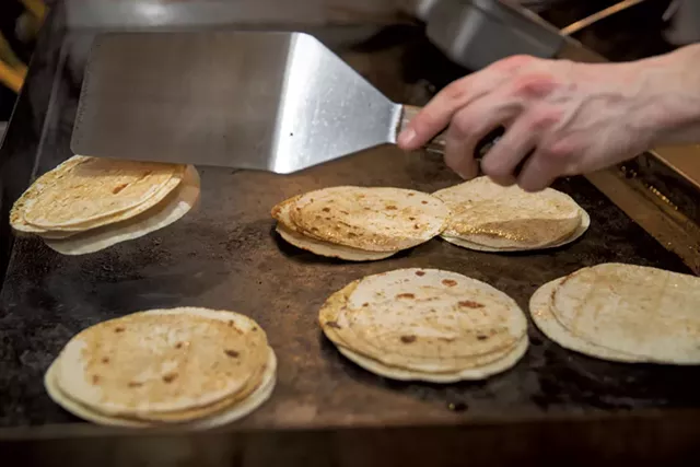 Preparing tortillas on the grill - JAMES BUCK