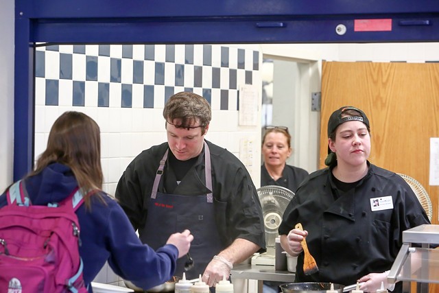 Hen of the Wood chef Jordan Ware serves lunch along with his sister Kate Dupee at Burlington High School - COURTESY OF BURLINGTON HIGH SCHOOL