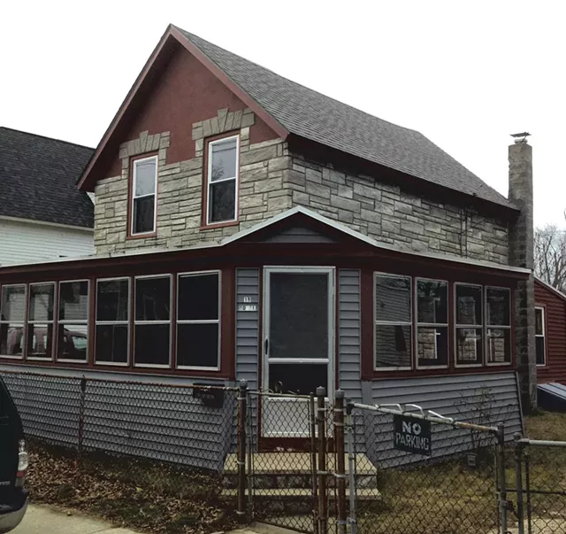 March 2013: When purchased, the circa-1913 house had concrete siding and an enclosed porch. A chain-link fence ran the border of its property. - COURTESY OF GRAHAM MACHARG