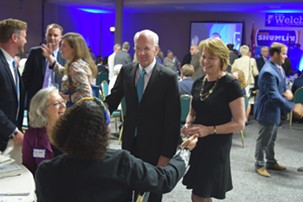 Congressman Peter Welch and his wife, Margaret Cheney, talk to Democrats at Friday night's party gathering. - TERRI HALLENBECK