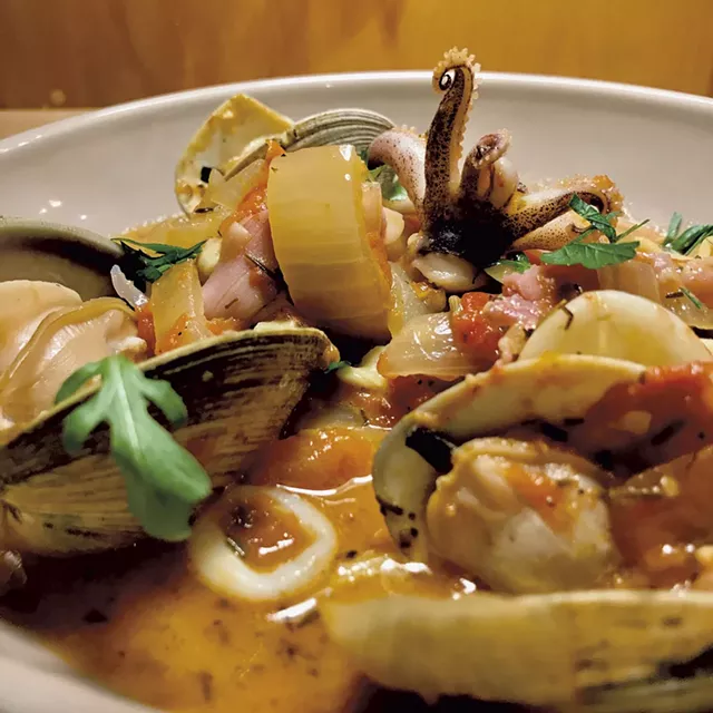 Clam sauté with squid, olives and prosciutto in tomato broth - COURTESY OF CHIP NATVIG