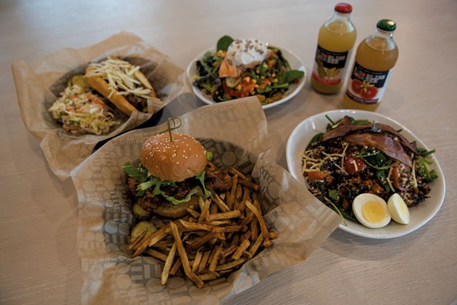 Clockwise from bottom: crispy chicken sandwich with hand-cut fries, Vermont hot dog, salmon salad, Bliss Bee sodas and a Sunrise grain bowl - DARIA BISHOP