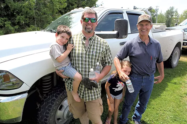 Kurt Magnan, his two kids and his father, Jim Magnan, after the merger vote - KEVIN MCCALLUM