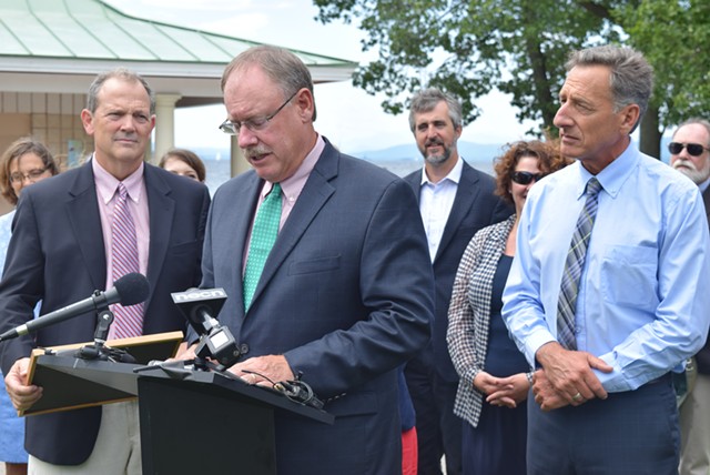 Curt Spalding, Region 1 administrator of the U.S. Environmental Protection Agency, speaks about a new  Lake Champlain cleanup agreement as Gov. Peter Shumlin looks on Friday at North Beach in Burlington. - TERRI HALLENBECK
