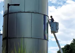 Mary Lacy painting the Dealer.com silos - MATTHEW THORSEN