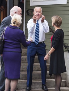 Then-vice president Joe Biden holding up coins he found outside Penny Cluse Café in October 2016 - POOL: GLENN RUSSELL/BURLINGTON FREE PRESS
